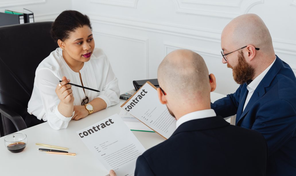 lawyer explaining a consulting contract to her clients